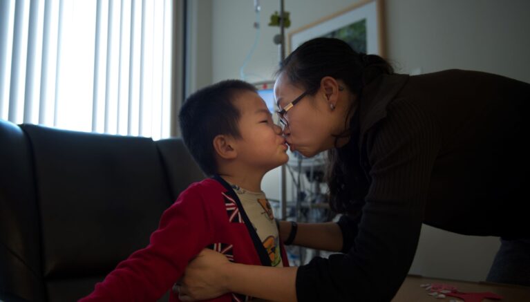 Mother kissing her son